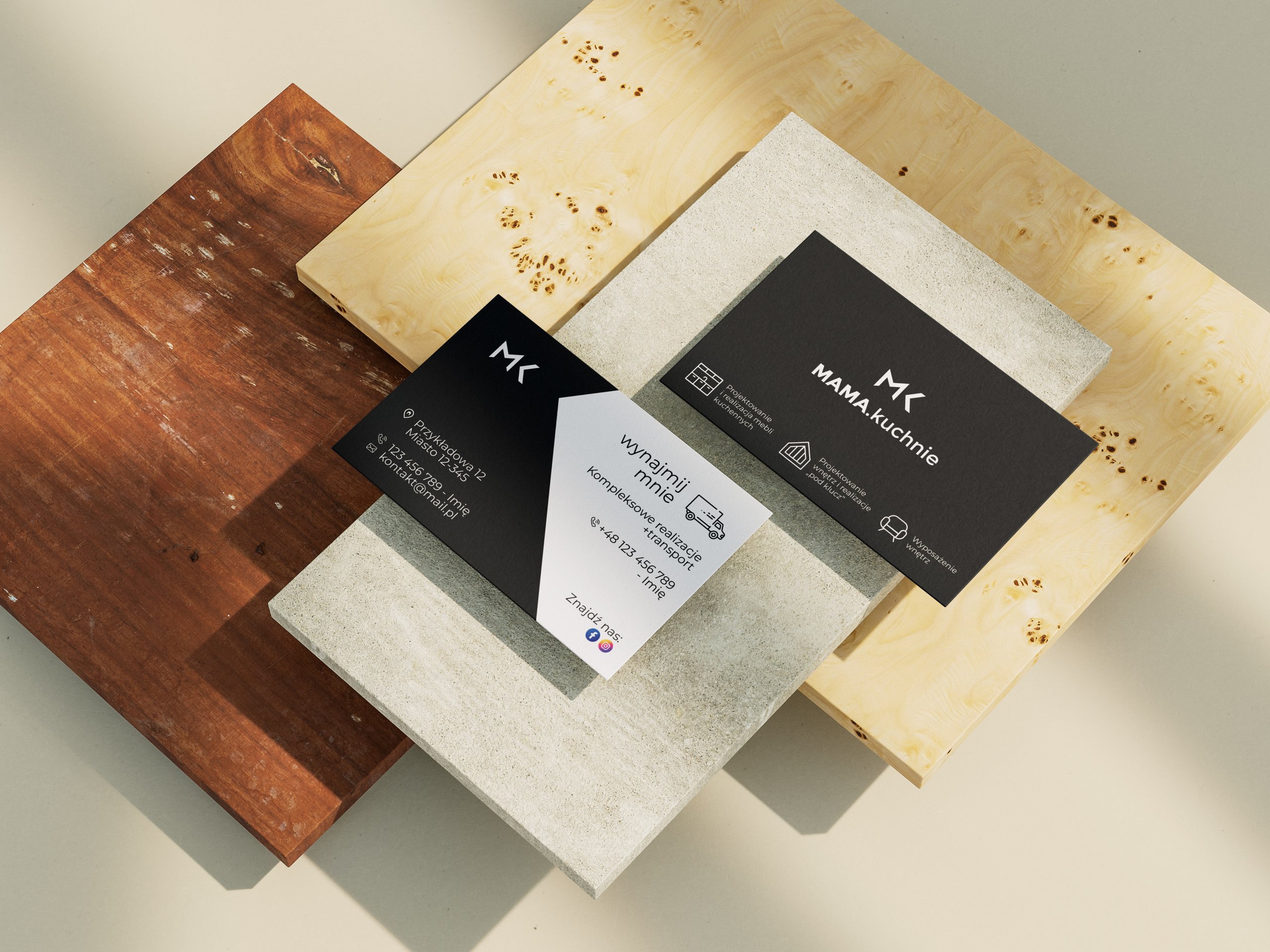 Diagonal business cards for “MAMMA.Kuchnie” arranged on overlapping wood and concrete slabs.