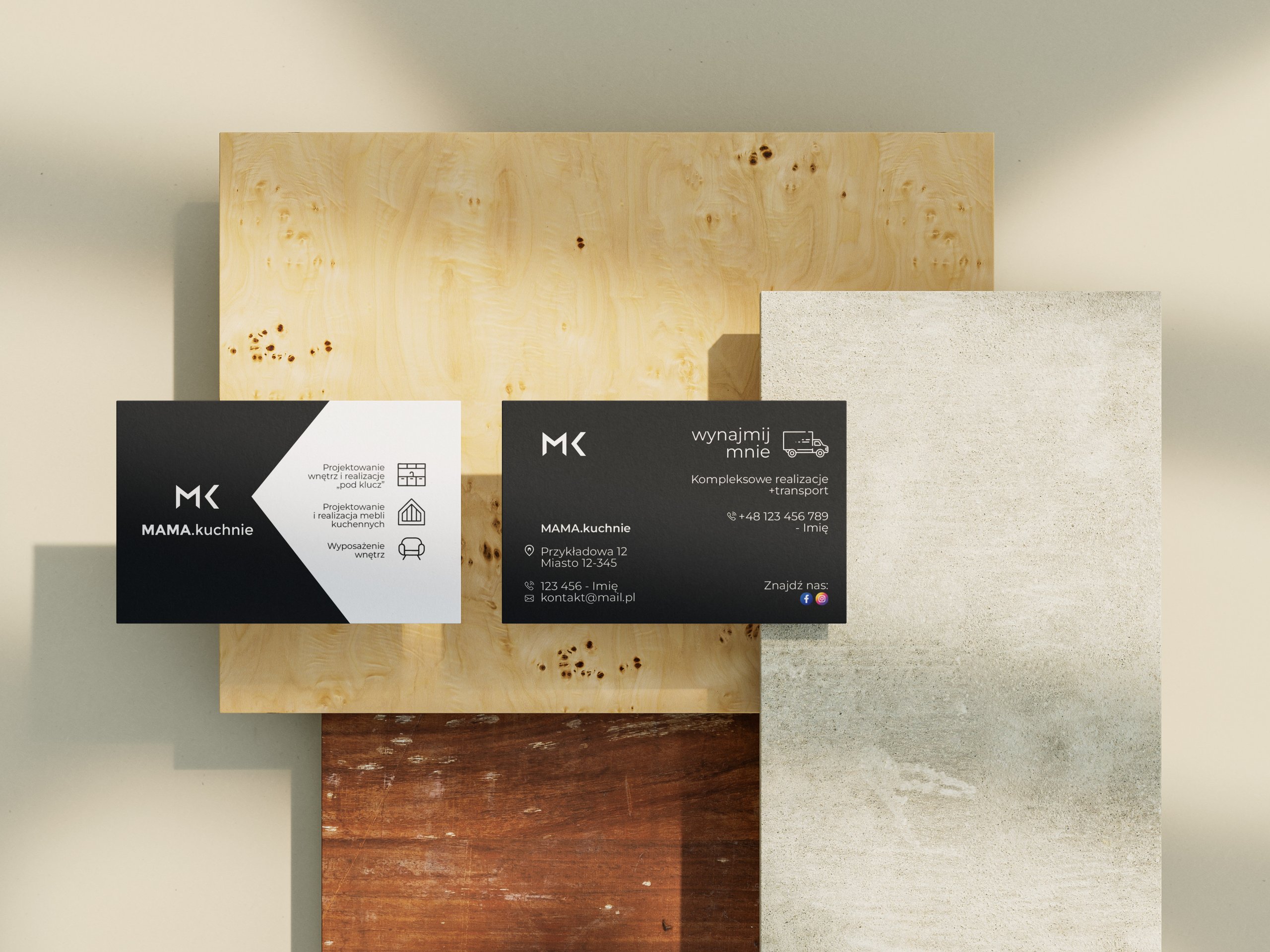 Two black-and-white “MAMA.kuchnie” business cards displayed on layered wood and concrete surfaces.