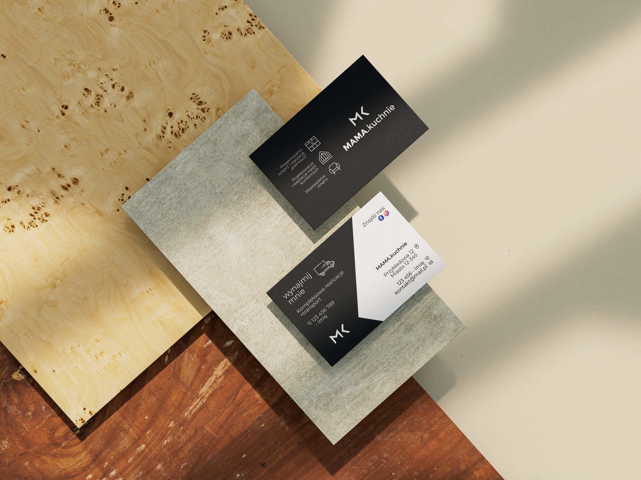 Diagonal wood and stone samples surround black and white Polish kitchen-design business cards.