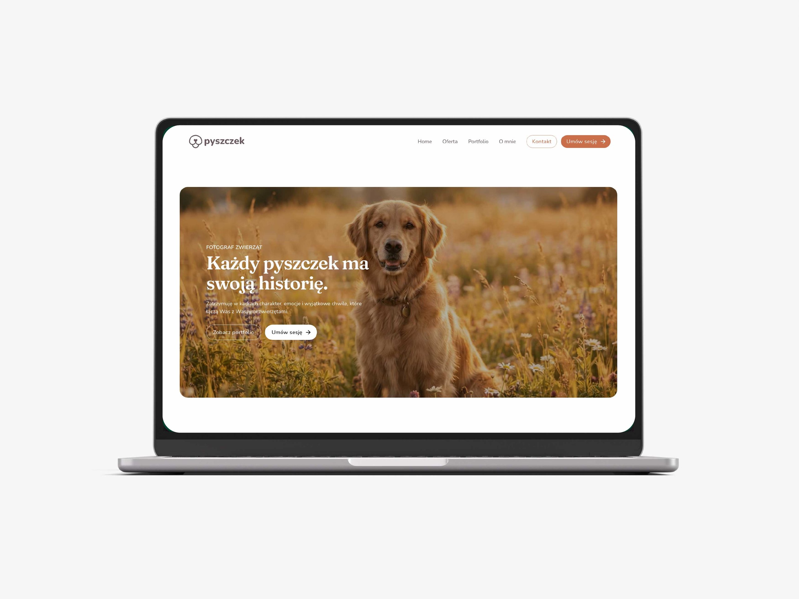 Laptop displaying a Polish pet photography website with a golden retriever in a sunlit meadow.